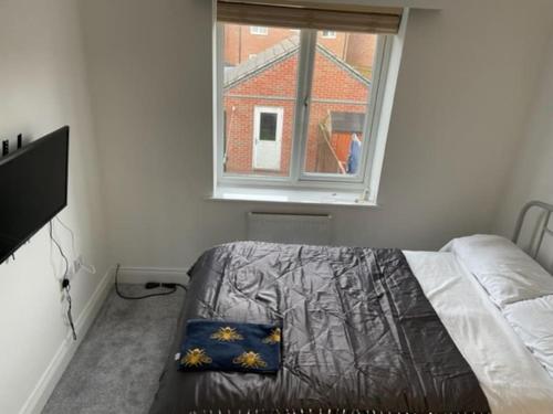 a bedroom with a bed and a window at *BRAND NEW* renovated 3 bed with parking & WIFI in Corby