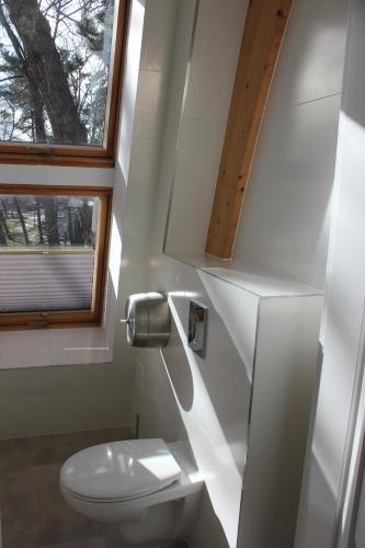 a small bathroom with a toilet and a window at Park in Sopot