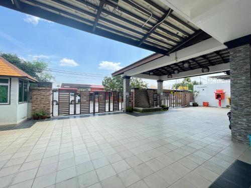 an outdoor patio with awning and a building at MR Homestay HotelStyle Room Teluk Intan in Teluk Intan