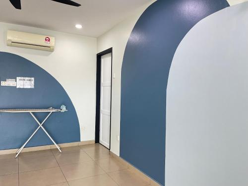 a room with a blue wall and a door at MR Homestay HotelStyle Room Teluk Intan in Teluk Intan