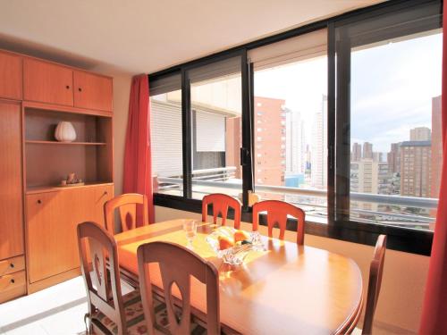 comedor con mesa y algunas ventanas en Apartment San Francisco by Interhome, en Benidorm