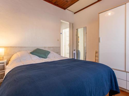 une chambre avec un grand lit avec une couverture bleue dans l'établissement Apartment Iena by Interhome, à Vieux-Boucau-les-Bains