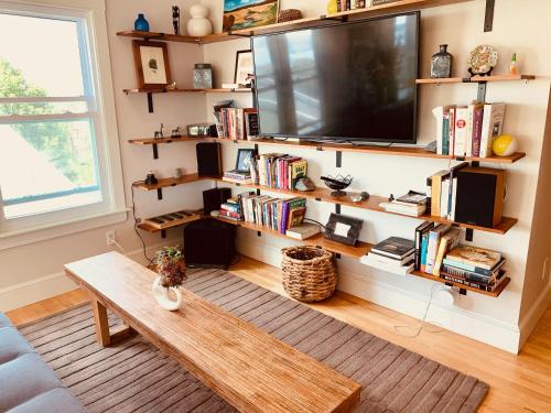 a living room with a flat screen tv on a wall at 62 Views in Portland