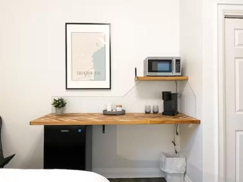 a room with a wooden counter with a microwave on it at Sleeping Giant BNB in Thunder Bay