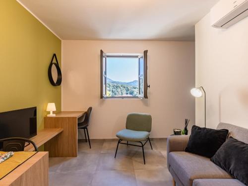 a living room with a couch and a table and a window at Apartment Padova T2 by Interhome in Corte