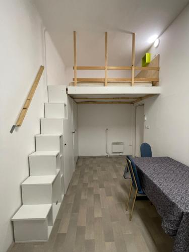 a room with stairs and a bed and a table at ICE APARTMENT in Ljubljana
