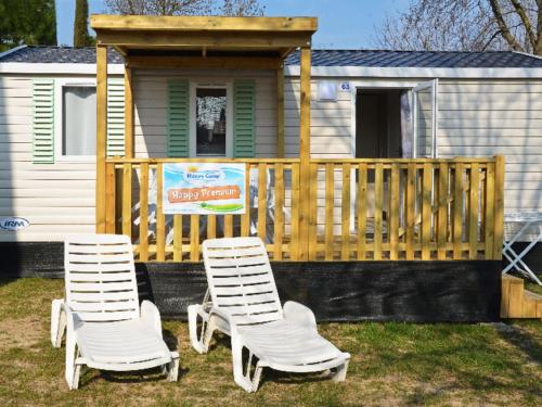 two chairs sitting in front of a tiny house at Holiday Home Camping Free Beach by Interhome in Marina di Bibbona
