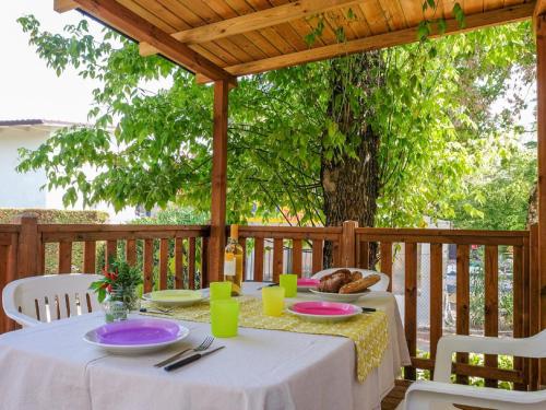 a table with plates of food on a wooden deck at Holiday Home Camping Free Beach by Interhome in Marina di Bibbona