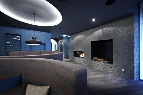 a living room with couches and a fireplace at Badhaus - Hotel/Restaurant/Café in Bad Hall