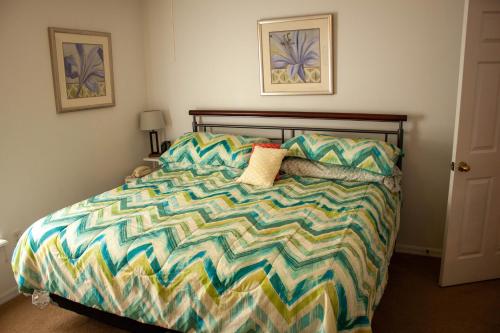 a bedroom with a bed with a colorful comforter at Florida Escape in Orlando