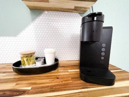 a coffee maker on a counter with a tray of drinks at Lake Superior Boutique Hotel in Thunder Bay