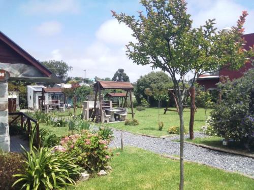 a garden with a playground and a gazebo at Complejo de Cabañas lo de Otto , Los Acantilados , Mar del plata in Mar del Plata