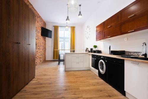 a kitchen with a washer and dryer at Big flat for groups - for 13 pax, 100sq in Krakow