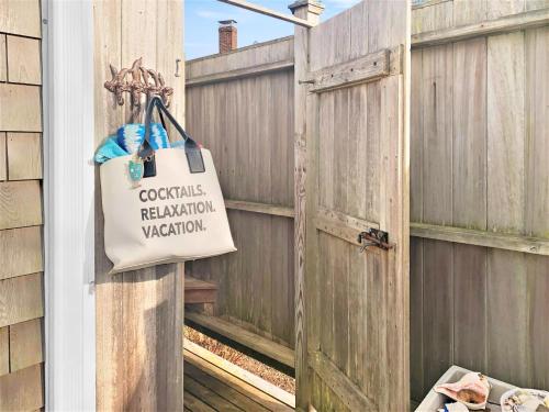 a shopping bag hanging on a wooden fence at 24 Sea Mist Lane Chatham Cape Cod - - The Sea Mist in South Chatham