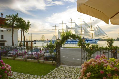 a view of a harbor with a boat in the water at Viktoria Palace Hotel in Venice-Lido