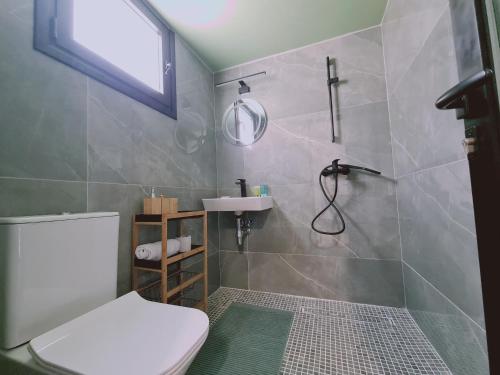 a bathroom with a toilet and a sink and a shower at STAY Vintage House in Limassol