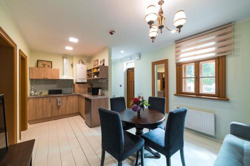 a kitchen and dining room with a table and chairs at Cottage Dzintars in Jūrmala