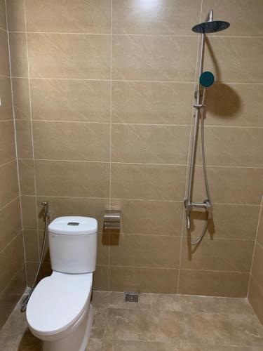 a bathroom with a toilet and a shower at LaLa Citadel Homestay in Hue