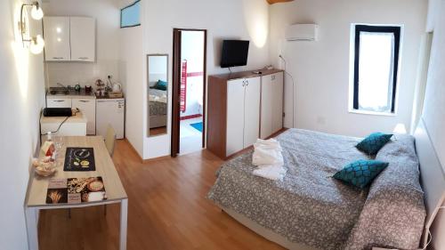 een kleine kamer met een bed en een keuken bij Da Enzo in Desenzano del Garda