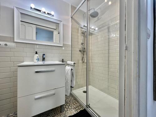 a white bathroom with a sink and a shower at Bright loft city centre by United Renters in Alicante