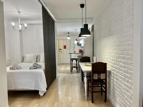 a bedroom with a bed and a dining room at Bright loft city centre by United Renters in Alicante