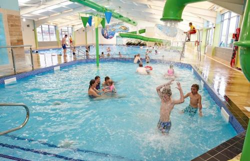 a group of people in a swimming pool at Golden Sands Pine Drive 53, 3 Bedrooms & Wi-fi in Mablethorpe