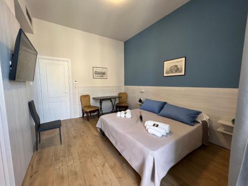 a bedroom with a bed and a table with chairs at B&B Costa degli Dei in Tropea