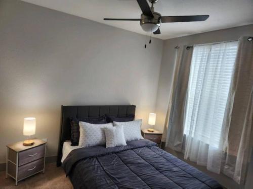 a bedroom with a bed and a ceiling fan at Luxurious 1 BR Apt in Ybor City in Tampa