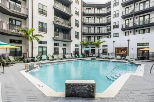 a swimming pool in the courtyard of a apartment building at Luxurious 1 BR Apt in Ybor City in Tampa