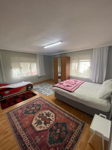 a bedroom with a large bed and a rug at Triplex house near the airport in Arnavutköy