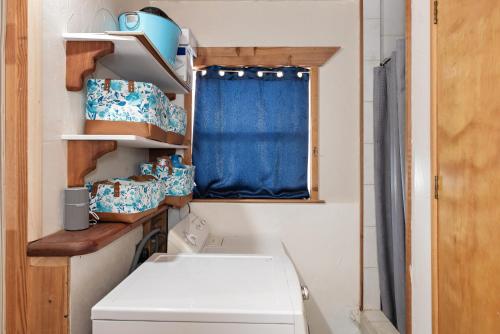 a kitchen with a washing machine and a window at Wanderer Studio, AN OFF GRID MOUNTAIN Guest Studio With Fantastic Views in Glenwood Springs