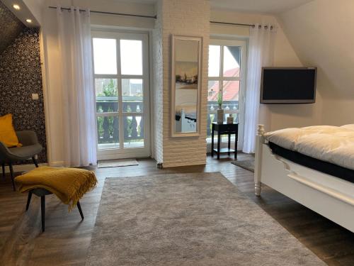 a bedroom with a bed and a television in it at Apartments-Bocholt in Bocholt