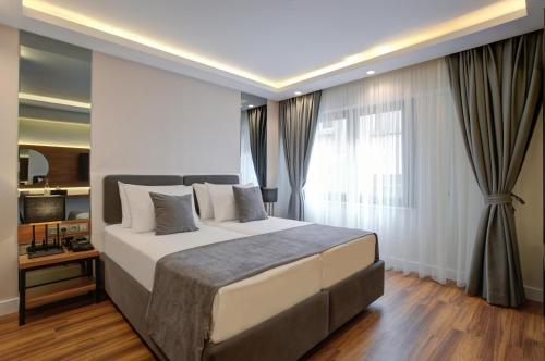 מיטה או מיטות בחדר ב-Depiero Hotel Karaköy