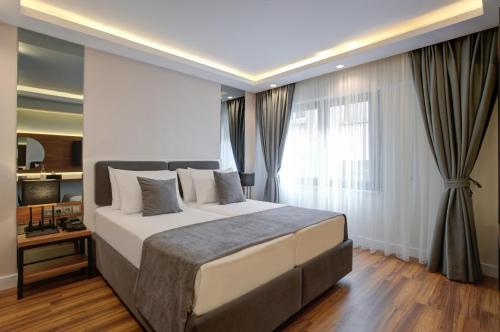 a bedroom with a large bed and a window at Depiero Hotel Karaköy in Istanbul