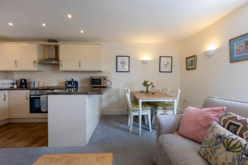 a kitchen and living room with a couch and a table at The Lemon Grove, Leyburn in Leyburn