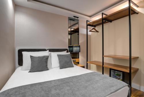 a bedroom with a bed with gray and white pillows at Depiero Hotel Karaköy in Istanbul