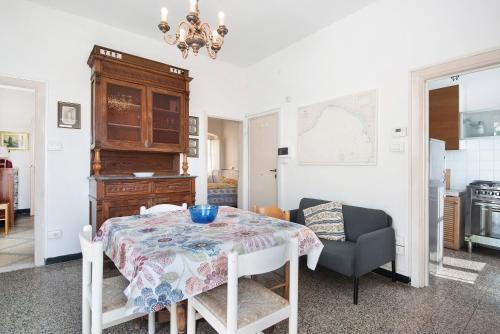 a dining room with a table and a chair at Rezzano 12 in Bonassola