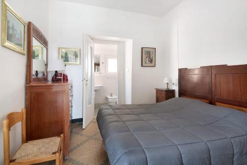 a bedroom with a large bed and a bathroom at Rezzano 12 in Bonassola