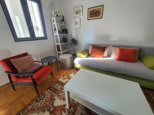 a living room with a couch and a chair at Delta Apartment in Podgorica