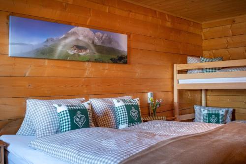 a bedroom with a bed with a tv on the wall at Bio Schartenalm in Mühlbach am Hochkönig