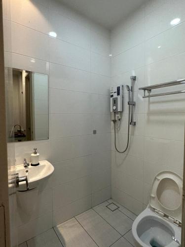 a bathroom with a shower and a toilet and a sink at Melaka Duplex Penthouse 3 Bedroom The Wave Residence 9pax in Melaka