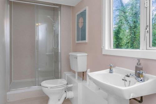 a bathroom with a toilet and a sink and a shower at Stylish country home near East Linton and Edinburgh in Whittingehame