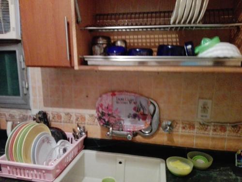 a kitchen counter with a sink and a dish rack at 13 خلف عمارات العبور مصر الجديده in Cairo