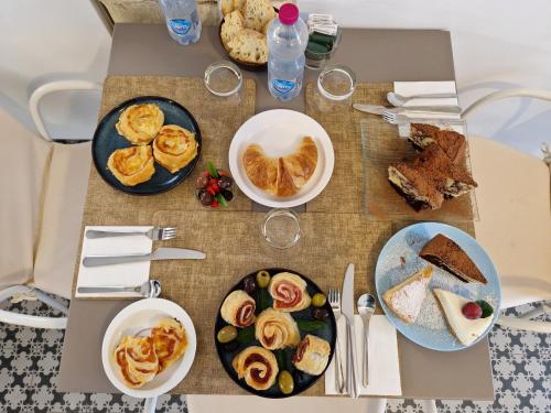 a table with plates of food on top of it at B&B Bianco E Blu in Marina di Ragusa