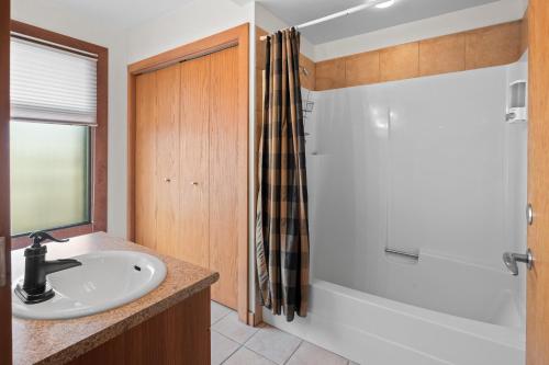 a bathroom with a white sink and a shower at Bridge View Suite by Iris Properties! in Victoria