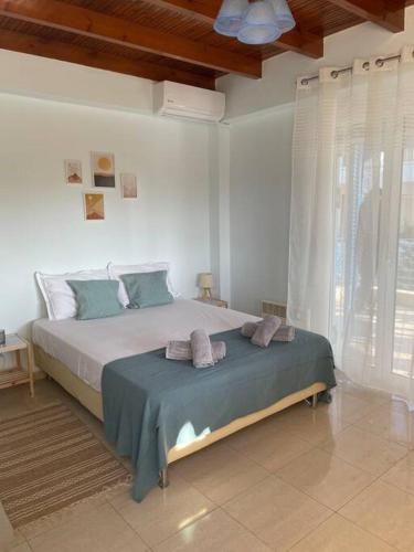 a bedroom with a large bed with towels on it at BlackMountain Room in Gythio