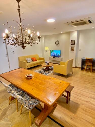 a living room with a table and a couch at The Palmian City Center Serviced Apartment in Ho Chi Minh City