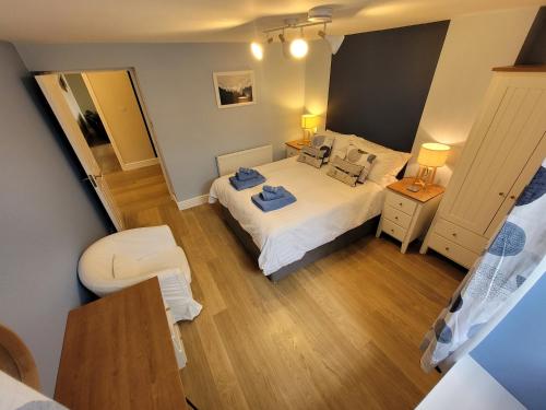 a small bedroom with a bed and a mirror at Llys Bach Apartment at Llys Aeron in Aberaeron