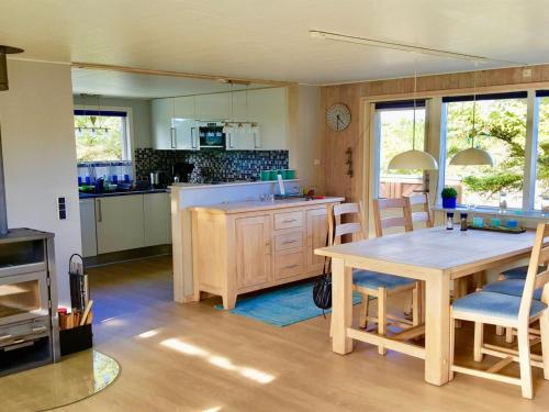 a kitchen and dining room with a table and chairs at Holiday Home Gudrid - all inclusive - 500m from the sea by Interhome in Fanø