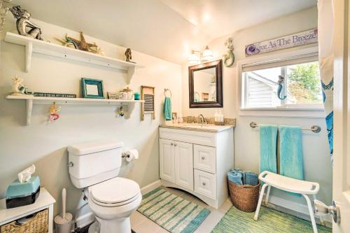 a bathroom with a toilet and a sink and a window at Lakeside Kent Home with Pier and Boat Ramp Access in Waterport